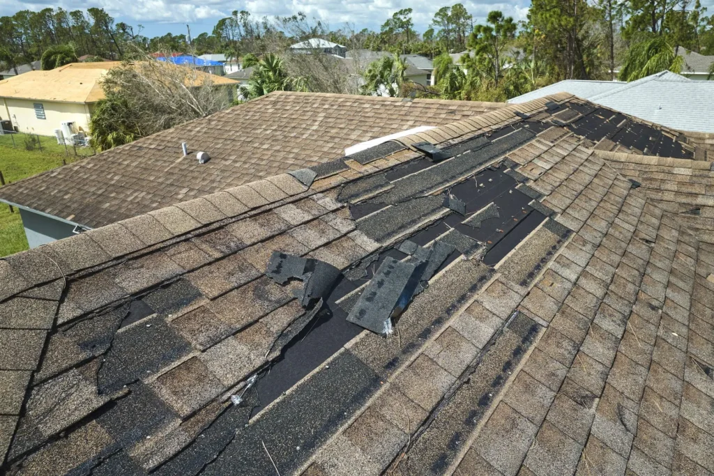 Storm damaged roof shingles needing repair in Omaha, NE